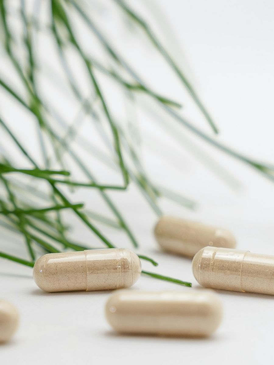 White capsules arranged on a surface