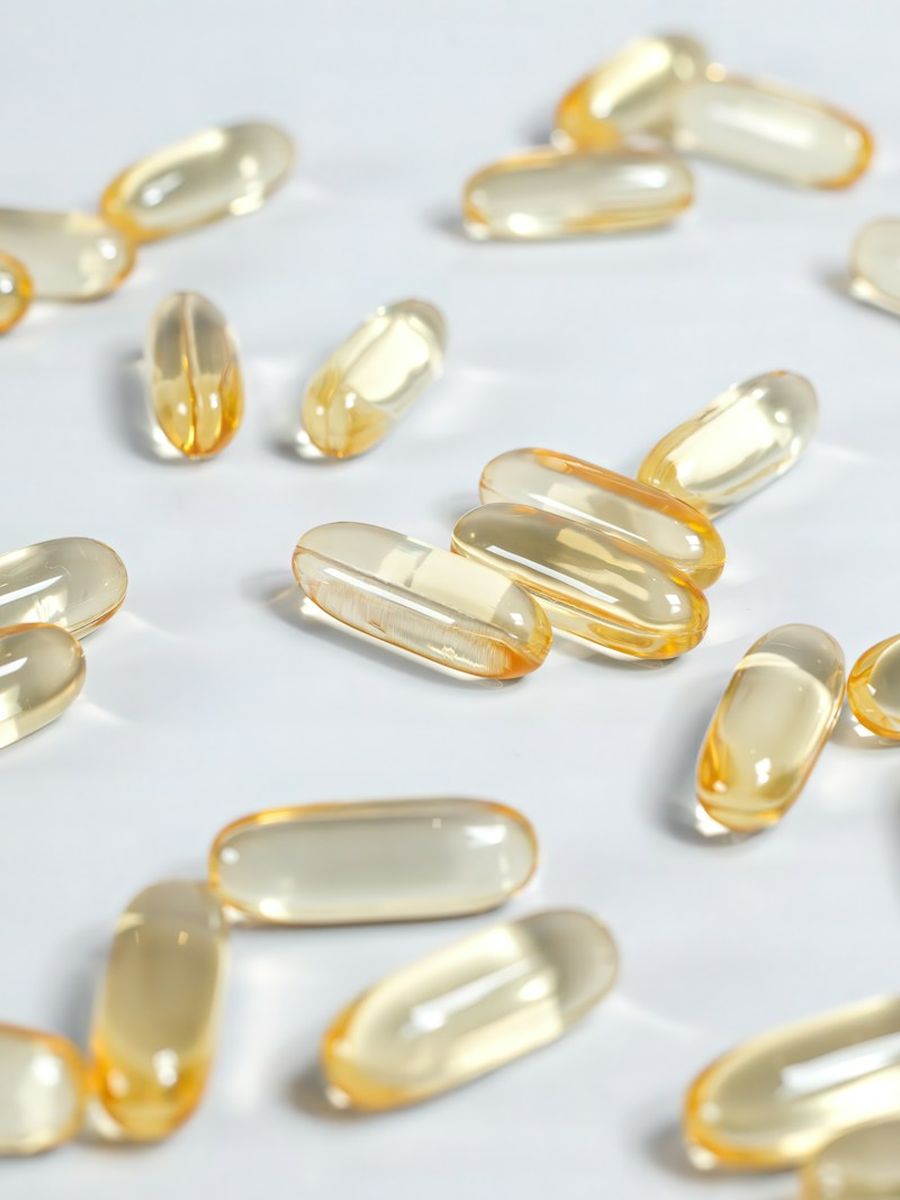 Softgel capsules on a light surface